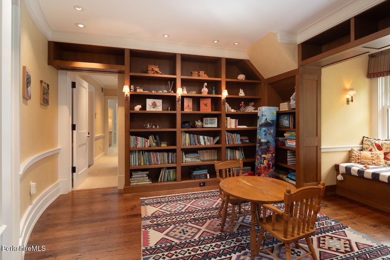 50 E Road Alford, MA 01266 - Photo 38 of 60 a living room with a couch and a book shelf