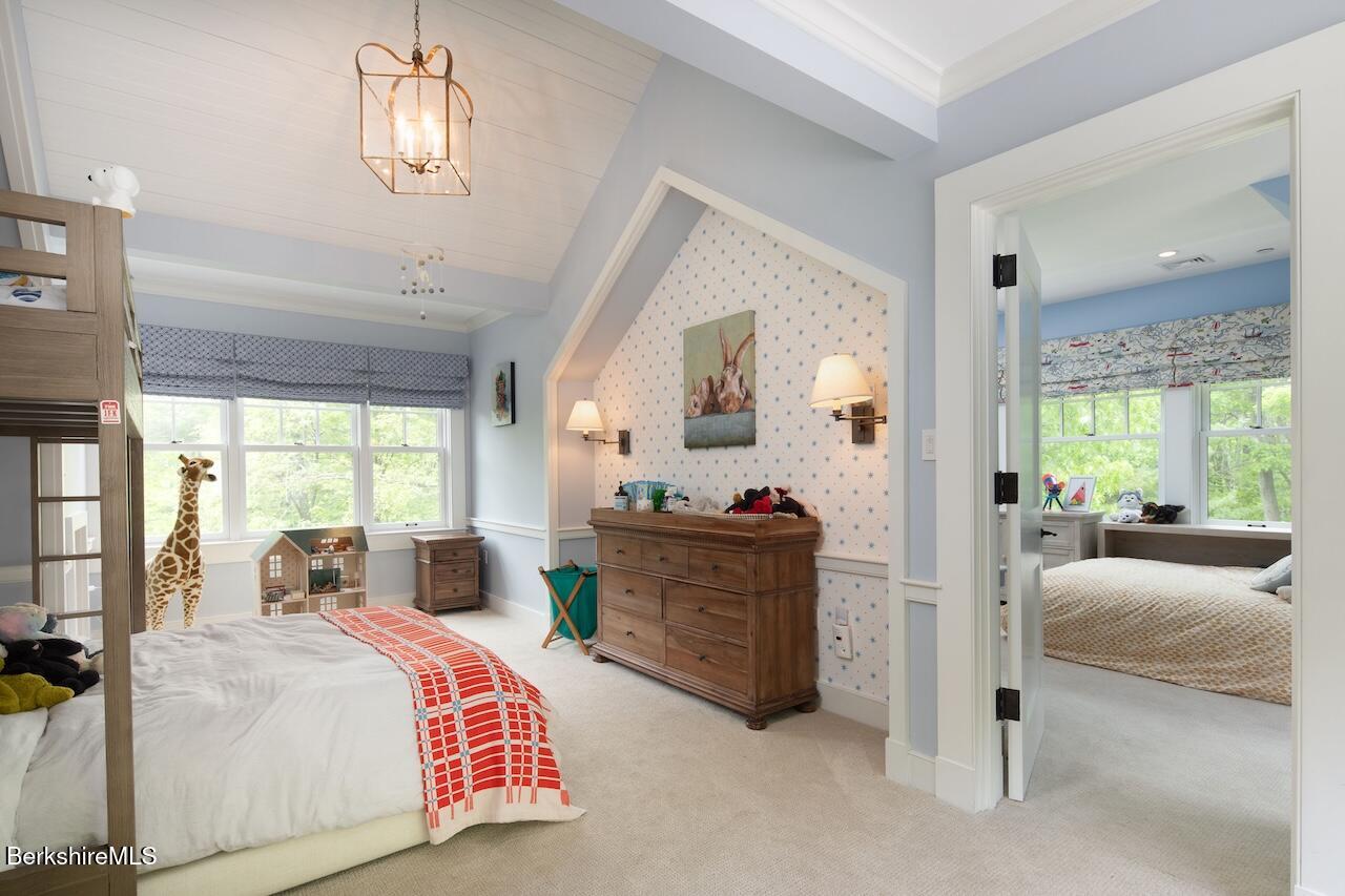 50 E Road Alford, MA 01266 - Photo 39 of 60 a bedroom with a bed and a chandelier
