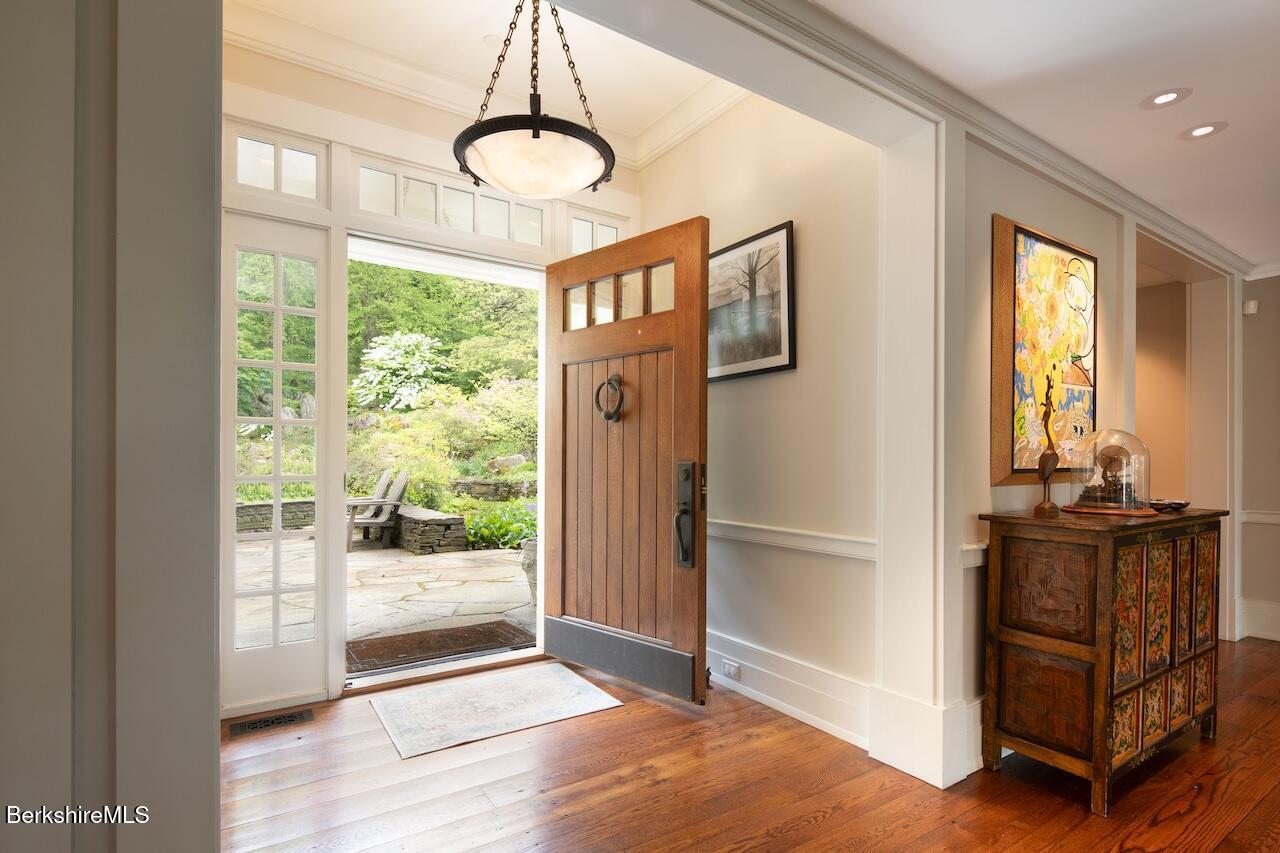 50 E Road Alford, MA 01266 - Photo 9 of 60 a view of a hallway with windows and chandelier