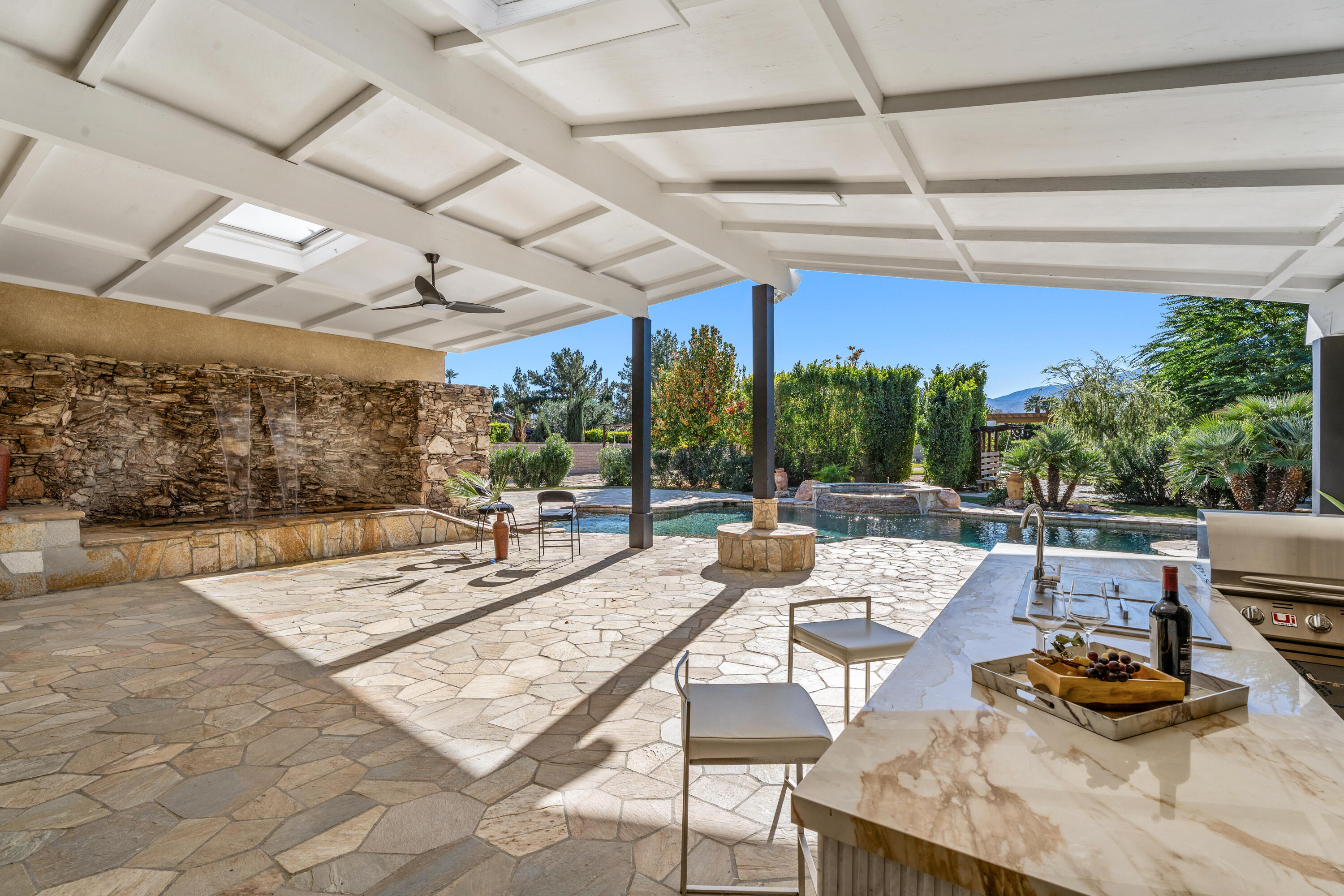 72114 Follansbee Road Rancho Mirage, CA 92270 - Photo 29 of 58 a view of a patio with a dining table and chairs with wooden floor