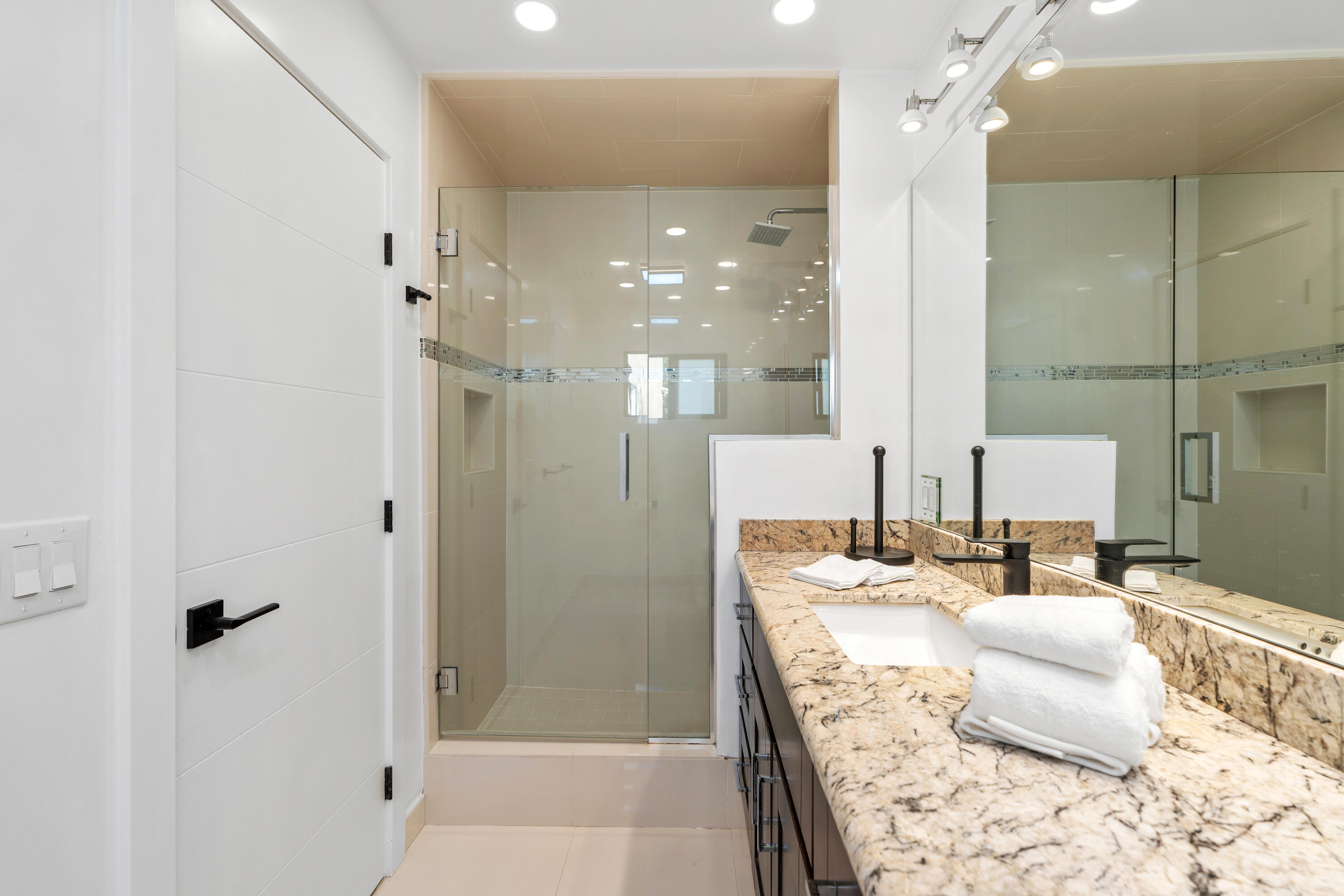72114 Follansbee Road Rancho Mirage, CA 92270 - Photo 38 of 58 a bathroom with a granite countertop sink a mirror and shower
