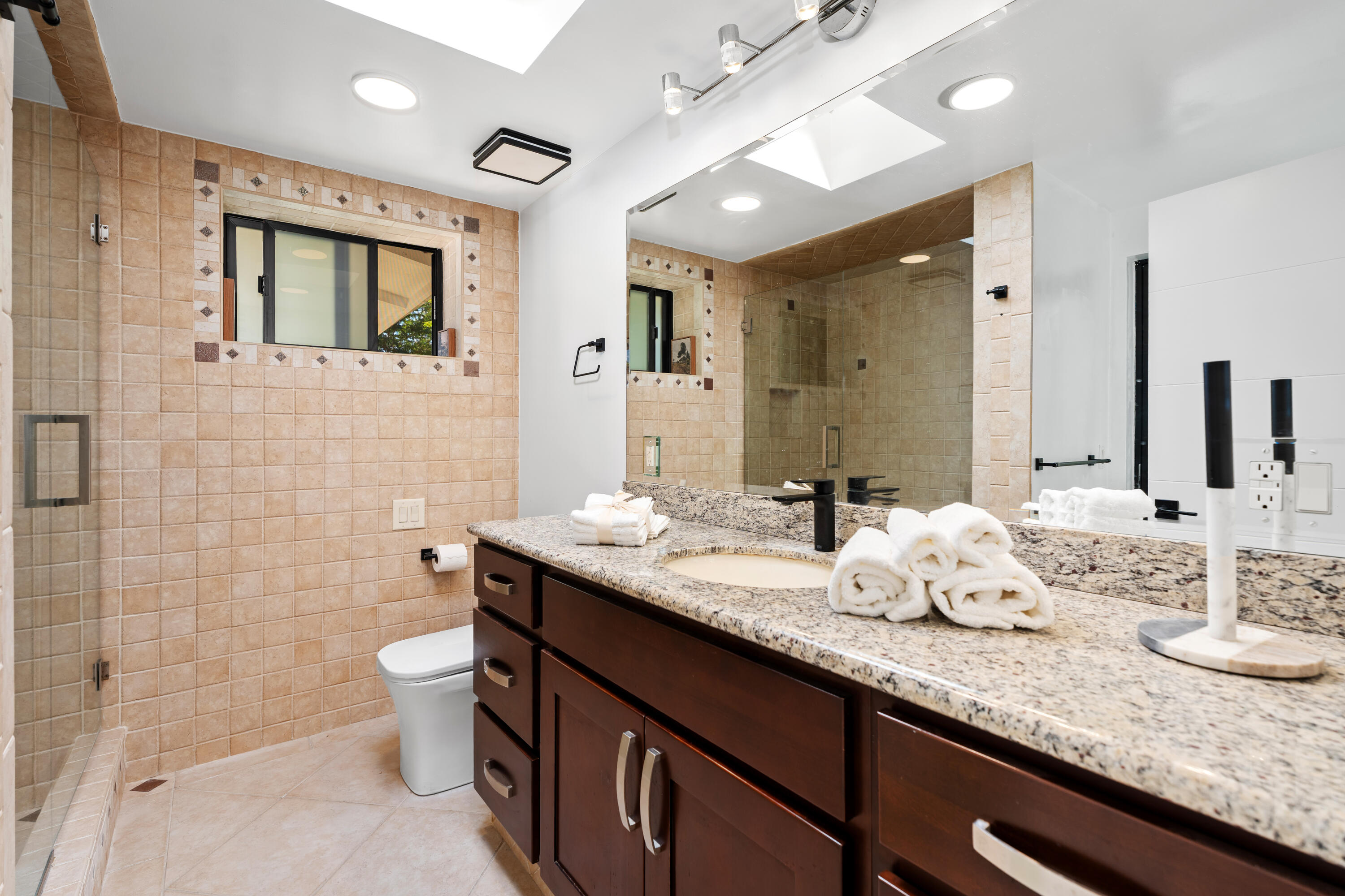 72114 Follansbee Road Rancho Mirage, CA 92270 - Photo 41 of 58 a bathroom with a granite countertop sink mirror vanity and toilet