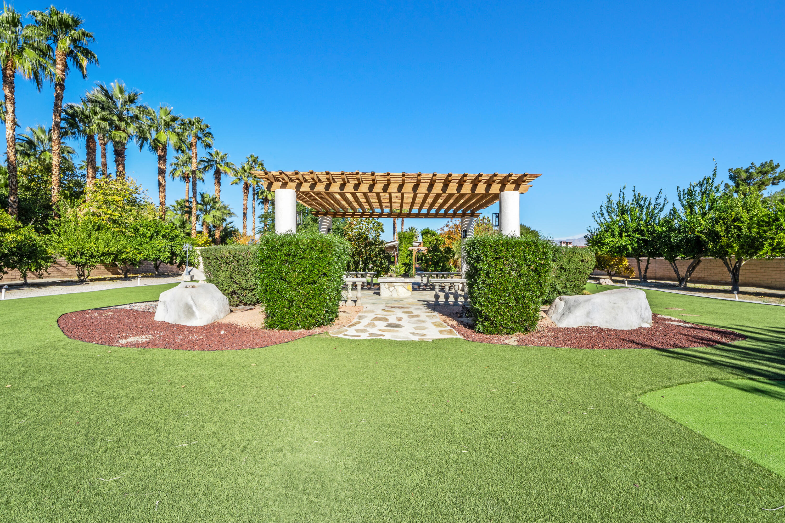 72114 Follansbee Road Rancho Mirage, CA 92270 - Photo 5 of 58 a view of a garden with a house