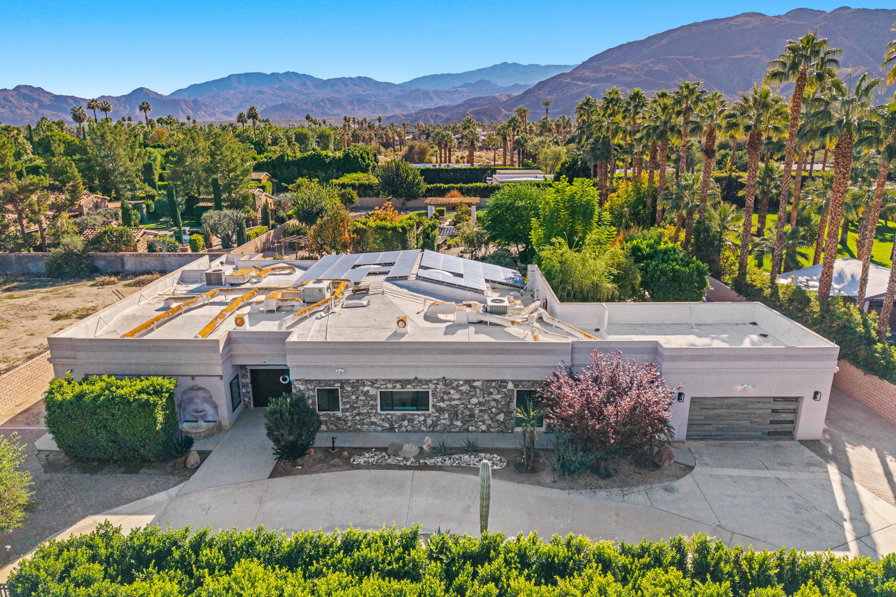 72114 Follansbee Road Rancho Mirage, CA 92270 - Photo 53 of 58 a view of a patio with a table and chairs under an umbrella
