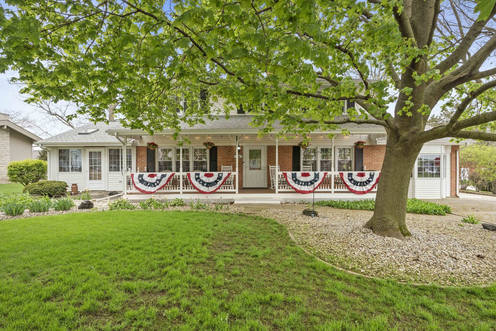 a front view of a house with yard and green space
