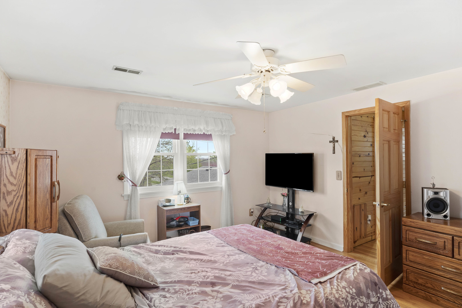 200 South Rathje Road Peotone, IL 60468 - Photo 22 of 39 a bedroom with a bed and a flat screen tv