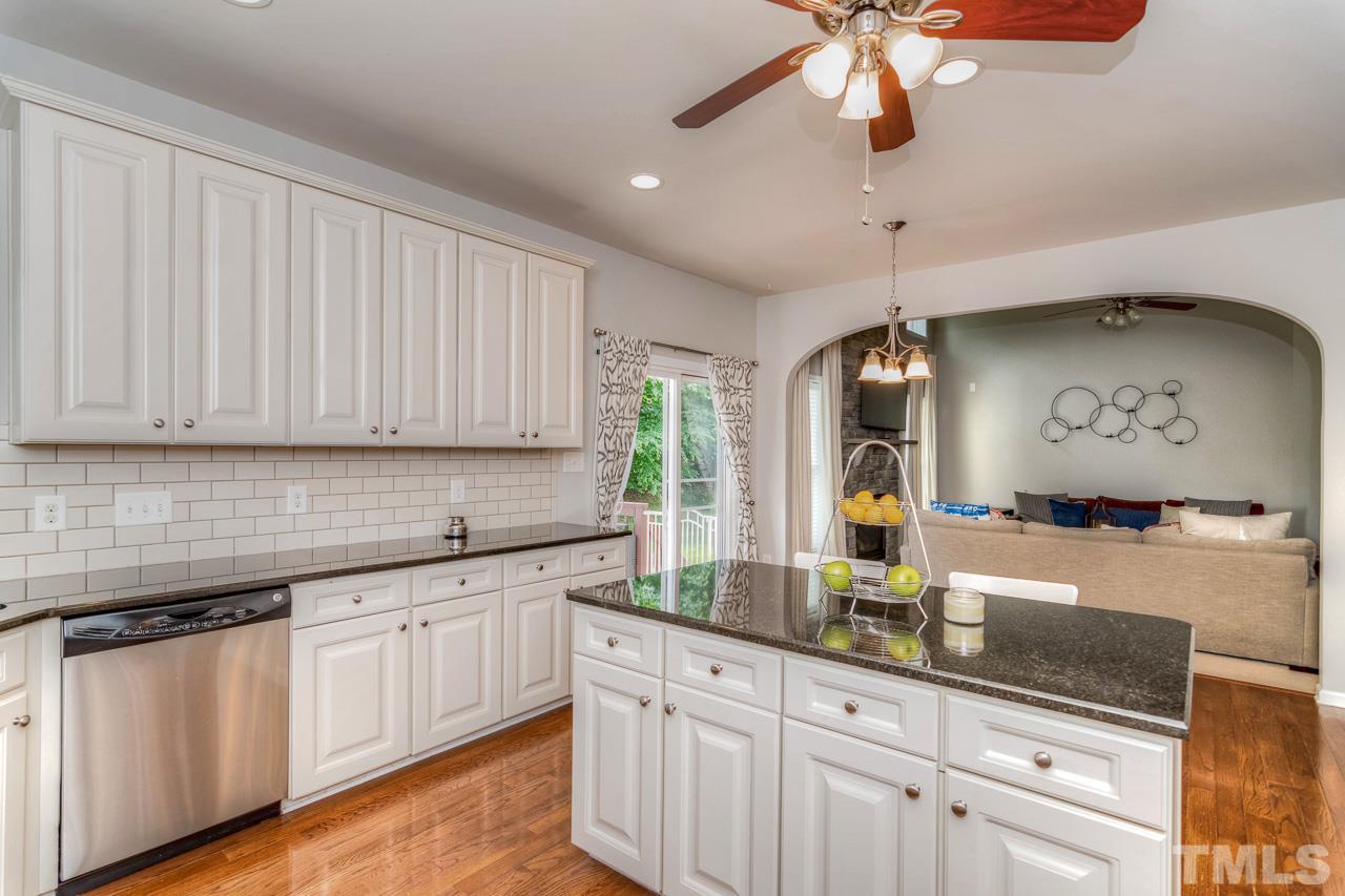 103 Key Biscayne Court Raleigh, NC 27603 - Photo 22 of 30 a kitchen with white cabinets and chandelier