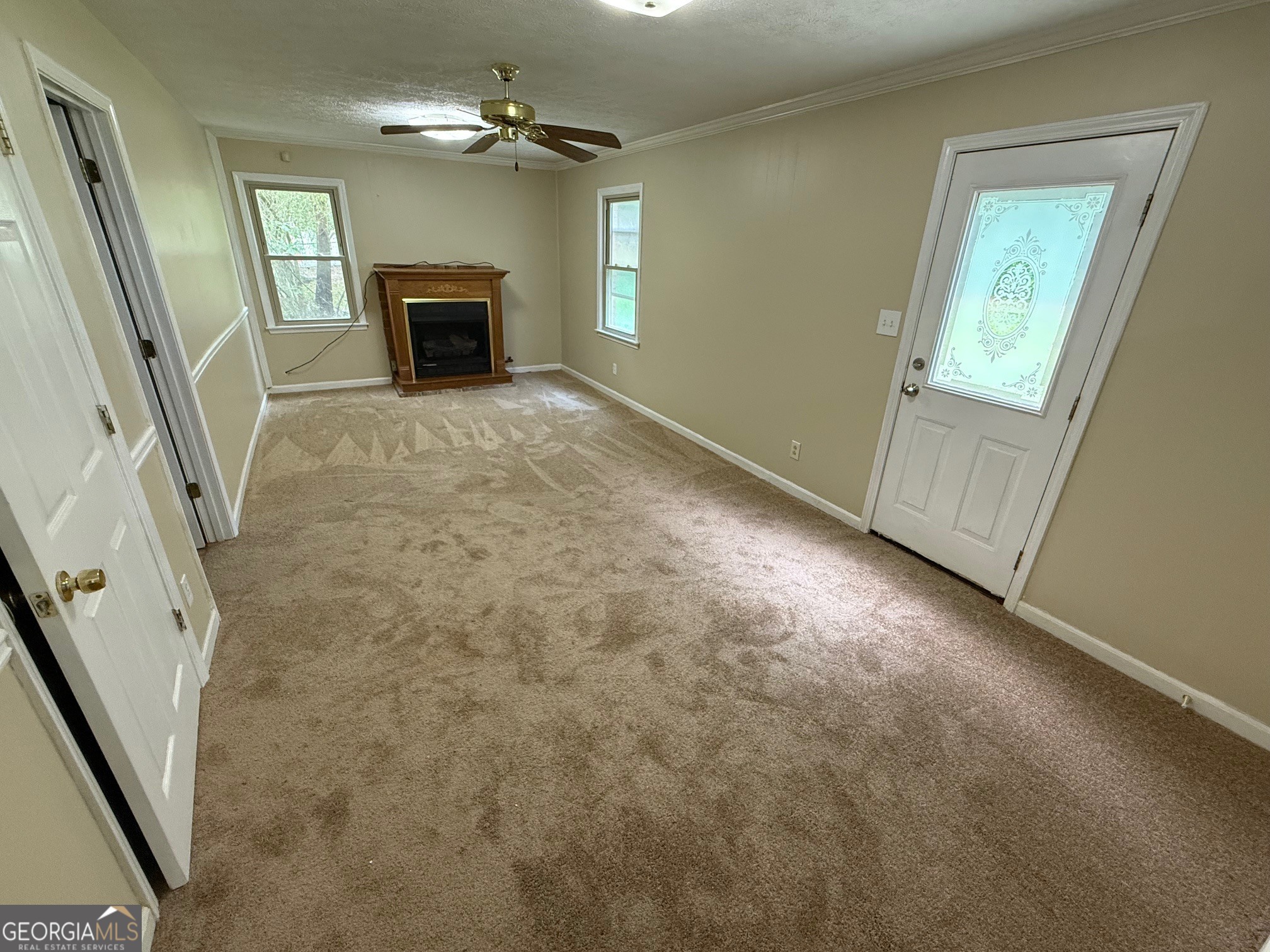2691 Falcon Ridge Drive Southwest Grayson, GA 30017 - Photo 4 of 10 an empty room with windows and fireplace