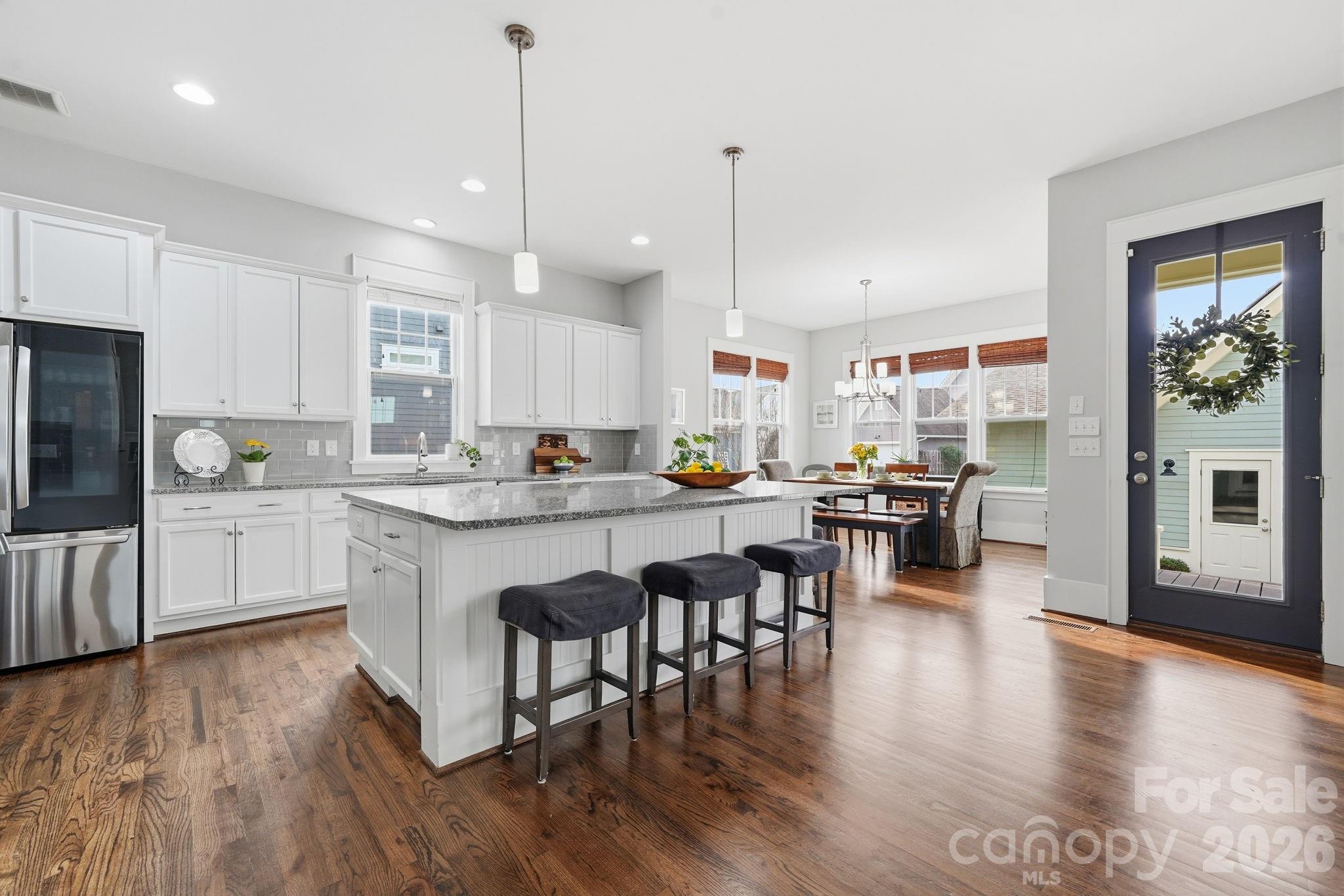 312 Mill Ridge Road Rock Hill, SC 29730 - Photo 7 of 42 a kitchen with stainless steel appliances granite countertop wooden floors refrigerator and cabinets