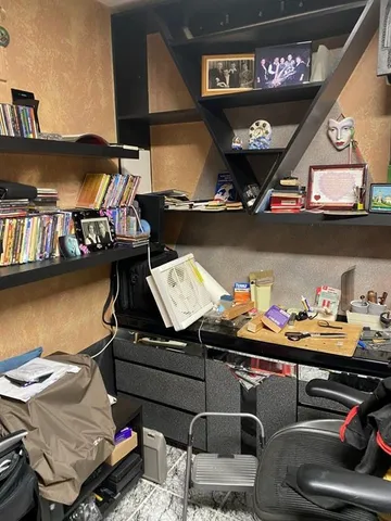 a room with lots of furniture and racks on the wall