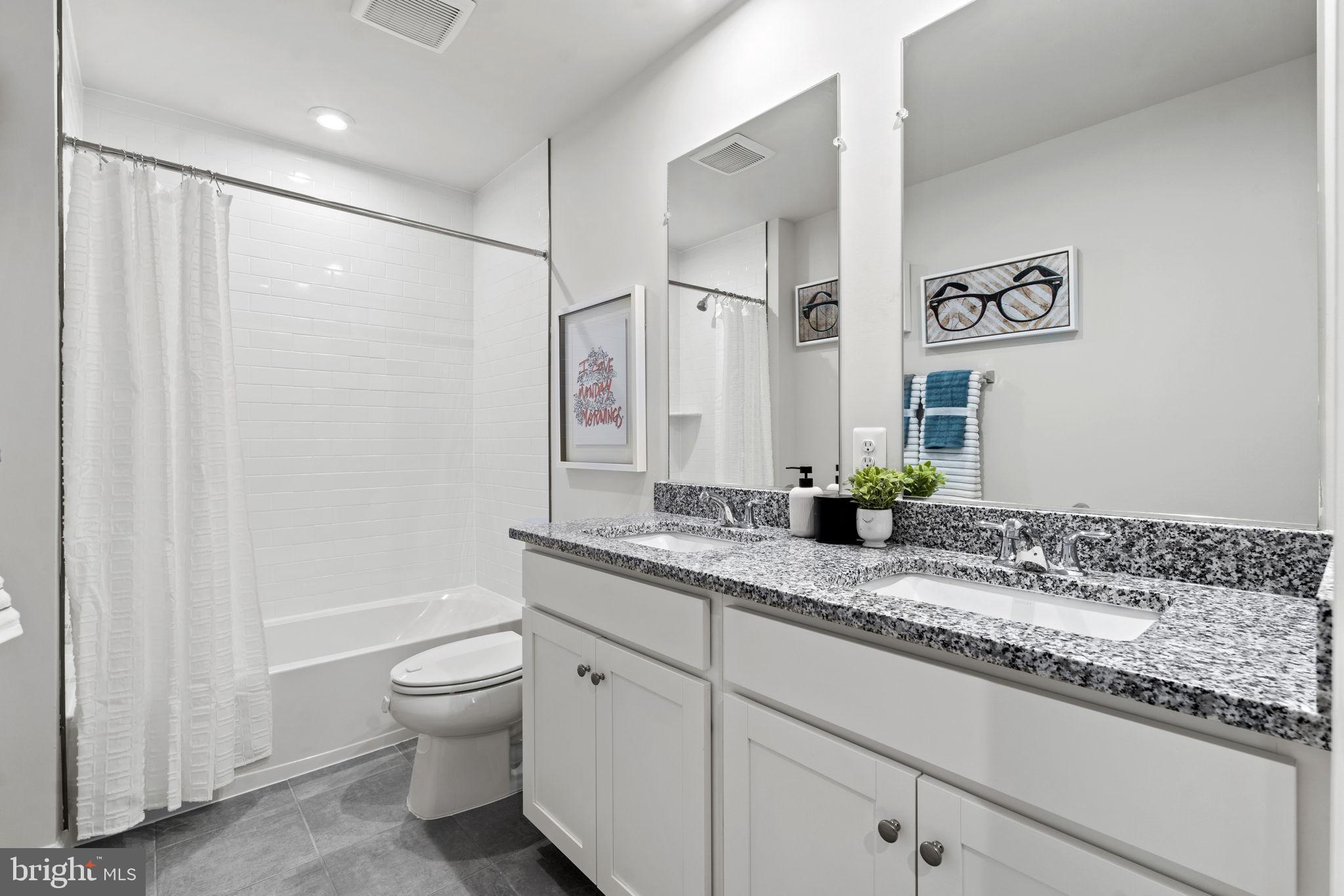 354 National Street Ranson, WV 25438 - Photo 17 of 39 a bathroom with a granite countertop sink a toilet and a shower