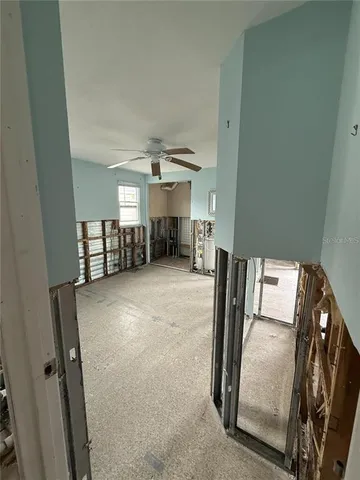 a view of a livingroom with furniture and a ceiling fan