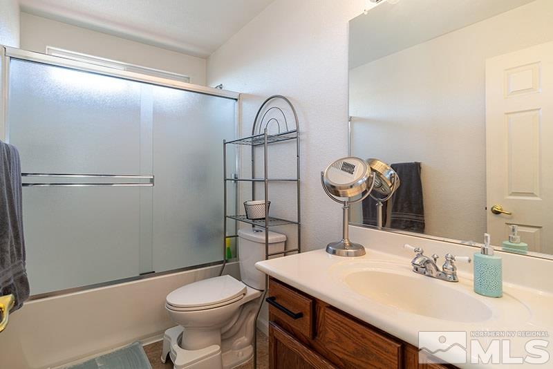 18366 Whitebark Court Reno, NV 89508 - Photo 15 of 36 a bathroom with a sink a toilet and a mirror