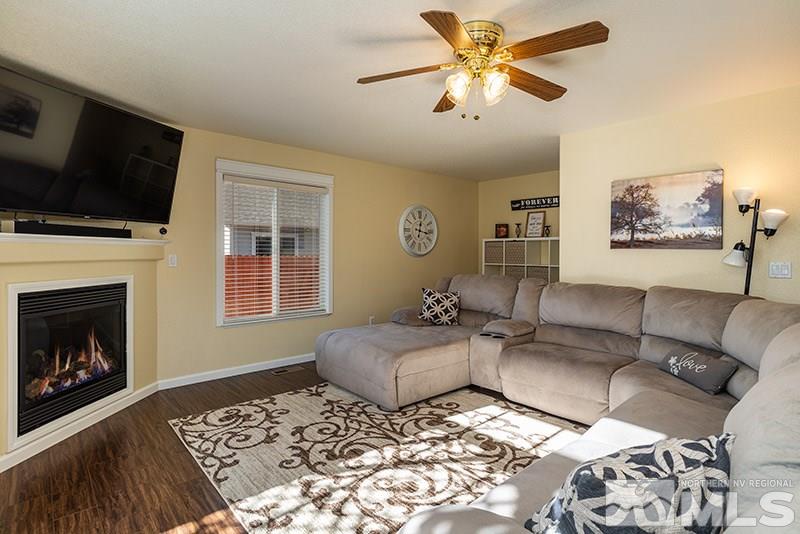 18366 Whitebark Court Reno, NV 89508 - Photo 16 of 36 a living room with furniture a flat screen tv and a fireplace