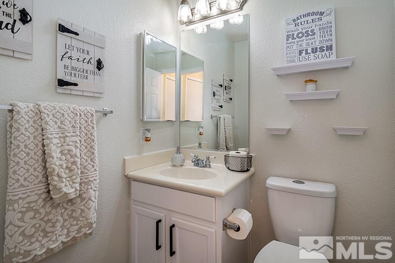 18366 Whitebark Court Reno, NV 89508 - Photo 19 of 36 a bathroom with a sink mirror vanity and toilet