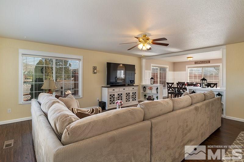 18366 Whitebark Court Reno, NV 89508 - Photo 20 of 36 a living room with furniture ceiling fan and a flat screen tv