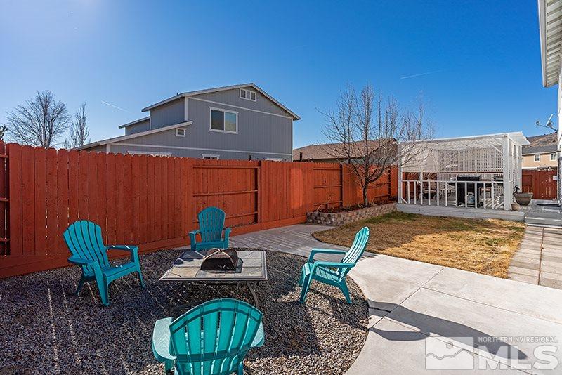 18366 Whitebark Court Reno, NV 89508 - Photo 27 of 36 a view of a house with backyard water fountain and sitting area