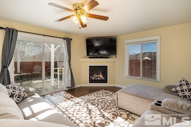 18366 Whitebark Court Reno, NV 89508 - Photo 5 of 36 a living room with furniture a flat screen tv and a fireplace