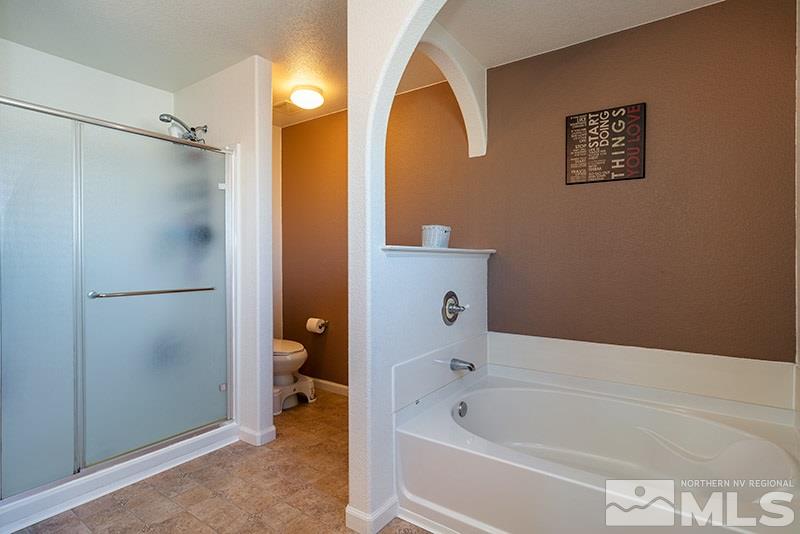 18366 Whitebark Court Reno, NV 89508 - Photo 9 of 36 a bathroom with a bathtub and a shower