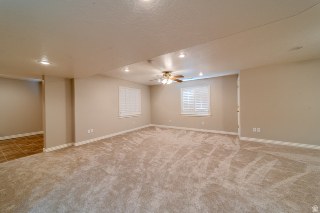 598 Hollow Creek Road Draper, UT 84020 - Photo 57 of 110 Spacious room featuring plush carpet flooring, recessed lighting, two windows with white plantation shutters, a ceiling fan, and neutral-toned walls