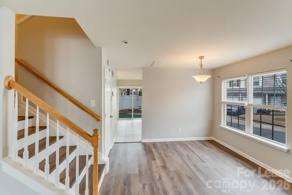a view of staircase with wooden floor and window