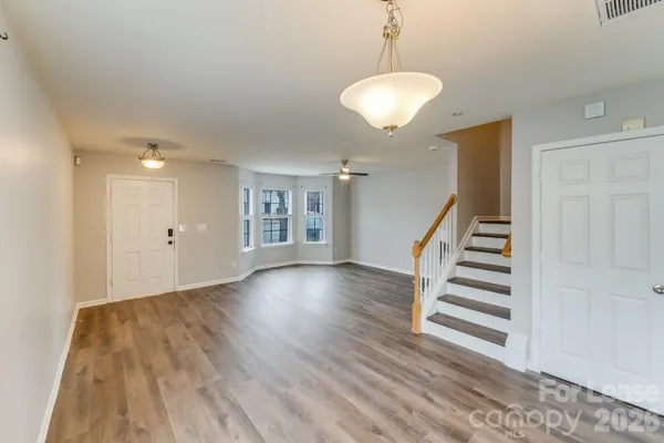 a view of entryway and hall with wooden floor