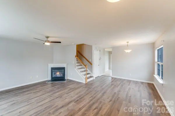 wooden floor in an empty room with a fireplace