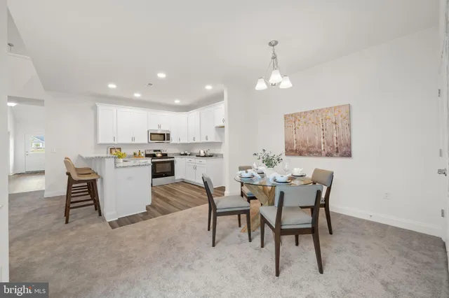 a view of a dining room with furniture and chandelier