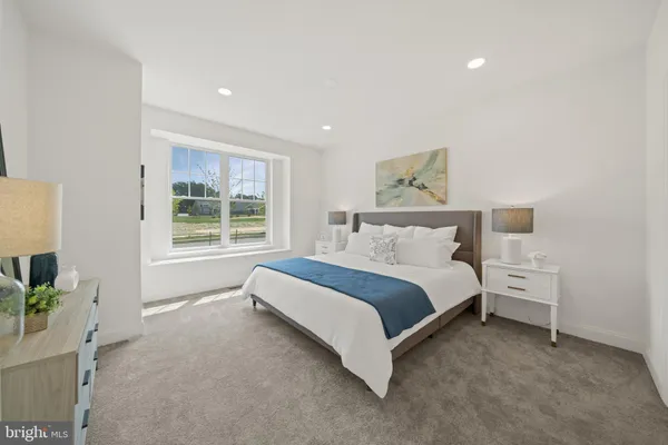 a spacious bedroom with a bed and a window