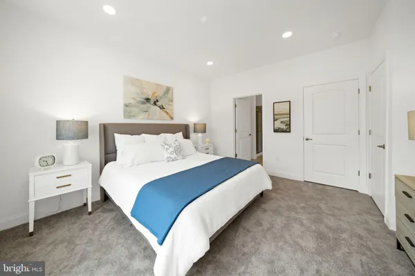 a bedroom with a bed and a painting on the wall