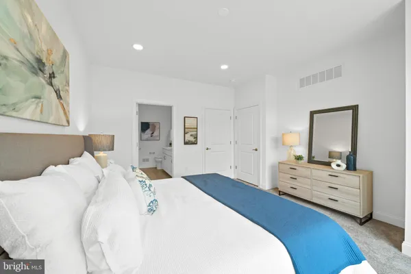 a bedroom with a bed and a dresser