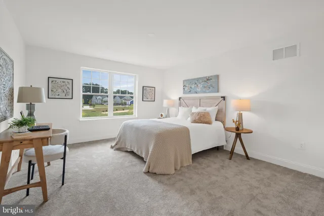 a spacious bedroom with a bed and a table in it