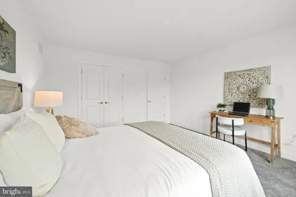 a bedroom with a bed and a desk