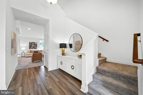 a view of living room kitchen with furniture and wooden floor
