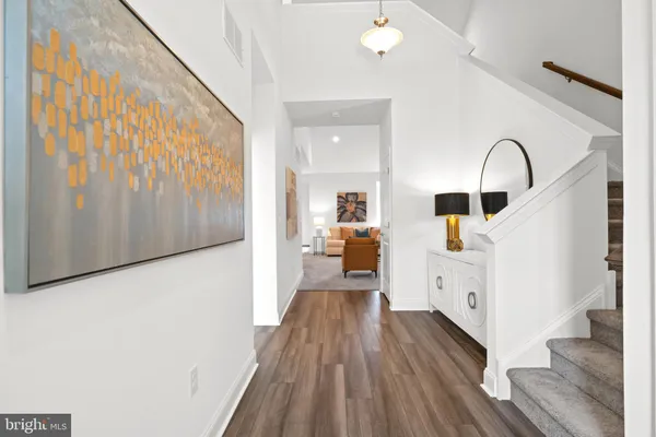 a view of living room with furniture and wooden floor
