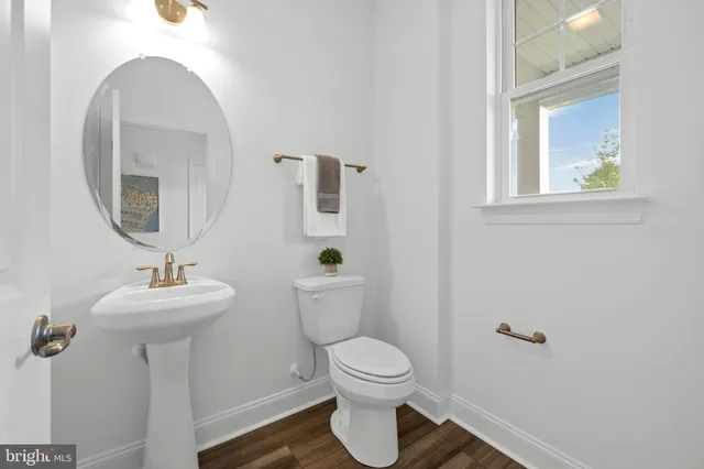 a bathroom with a sink mirror toilet and a mirror