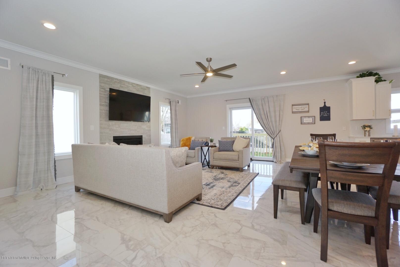 31 Torrice Loop Staten Island, NY 10309 - Photo 17 of 69 a living room with furniture a flat screen tv and a window