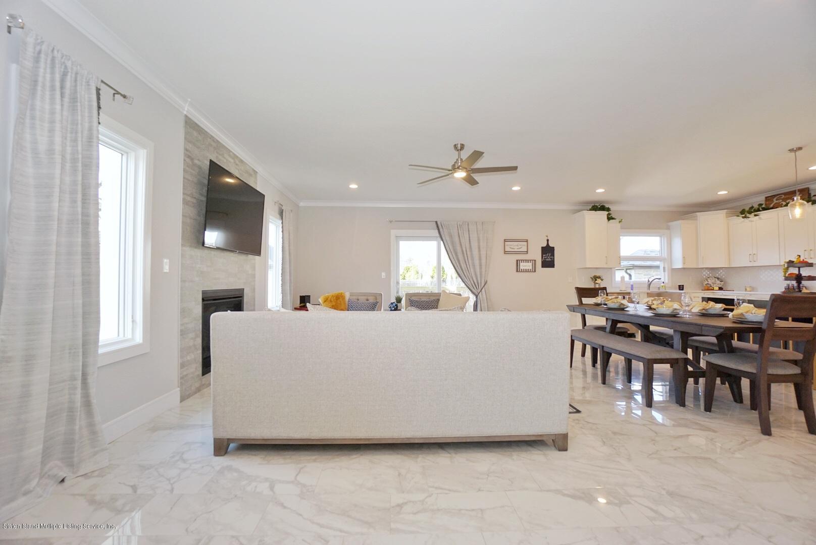 31 Torrice Loop Staten Island, NY 10309 - Photo 18 of 69 a living room with furniture a dining table and kitchen view