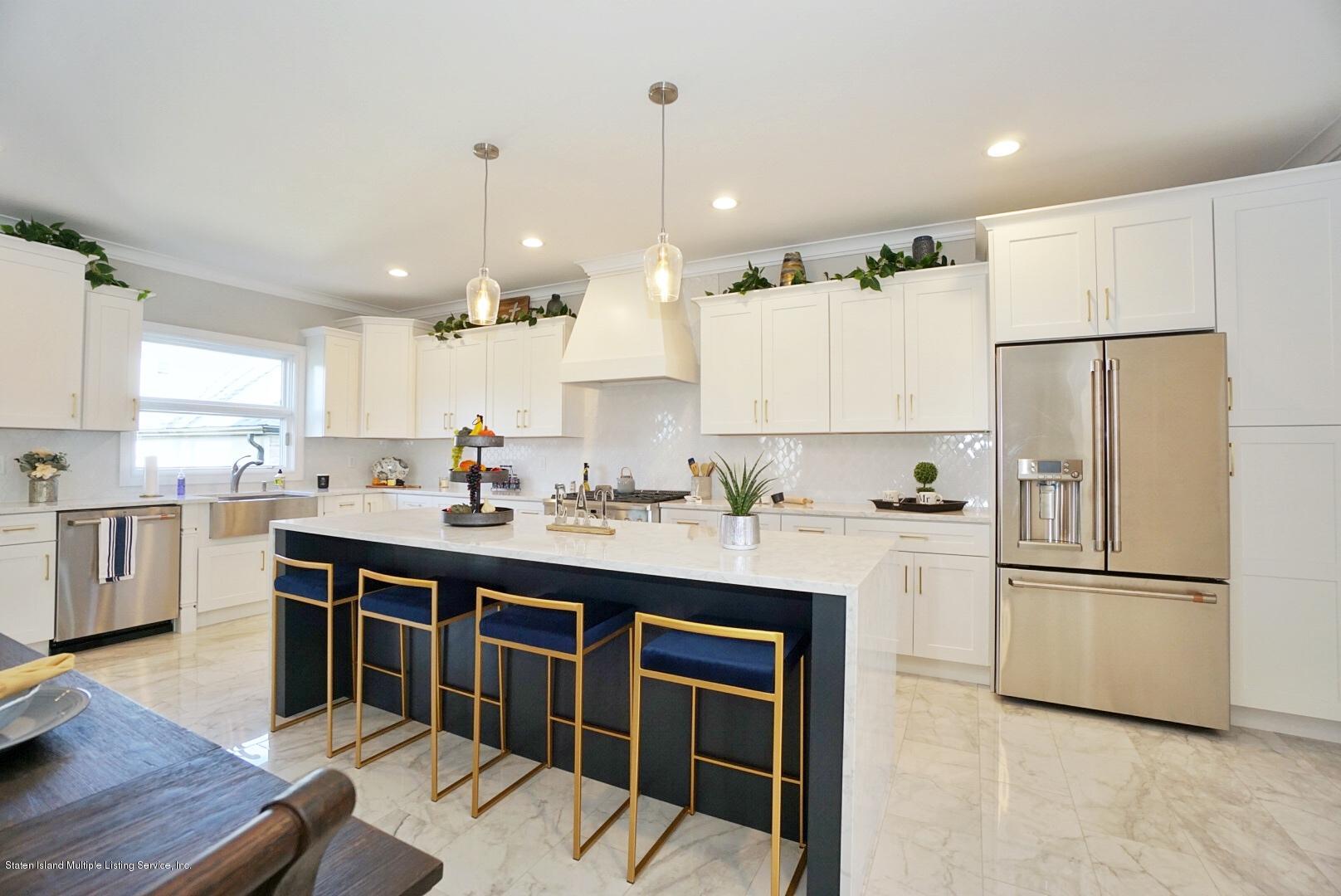 31 Torrice Loop Staten Island, NY 10309 - Photo 27 of 69 a kitchen with kitchen island a sink stainless steel appliances and cabinets