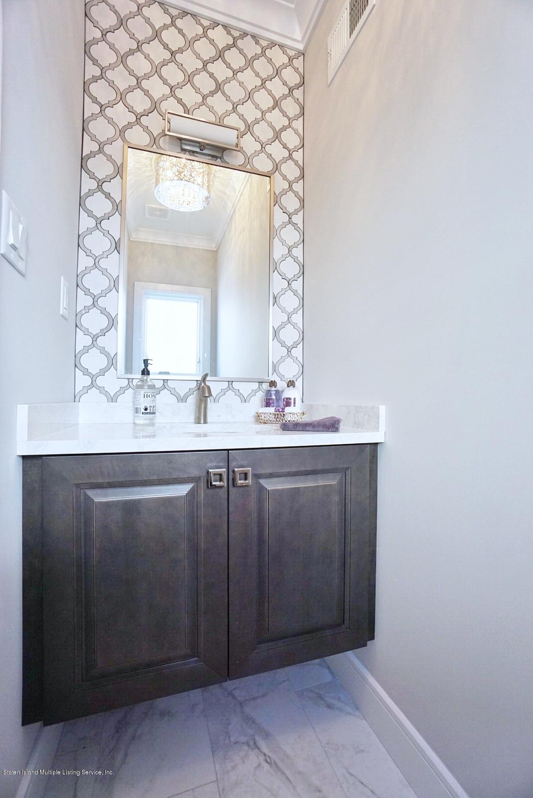31 Torrice Loop Staten Island, NY 10309 - Photo 29 of 69 a bathroom with a sink vanity and mirror