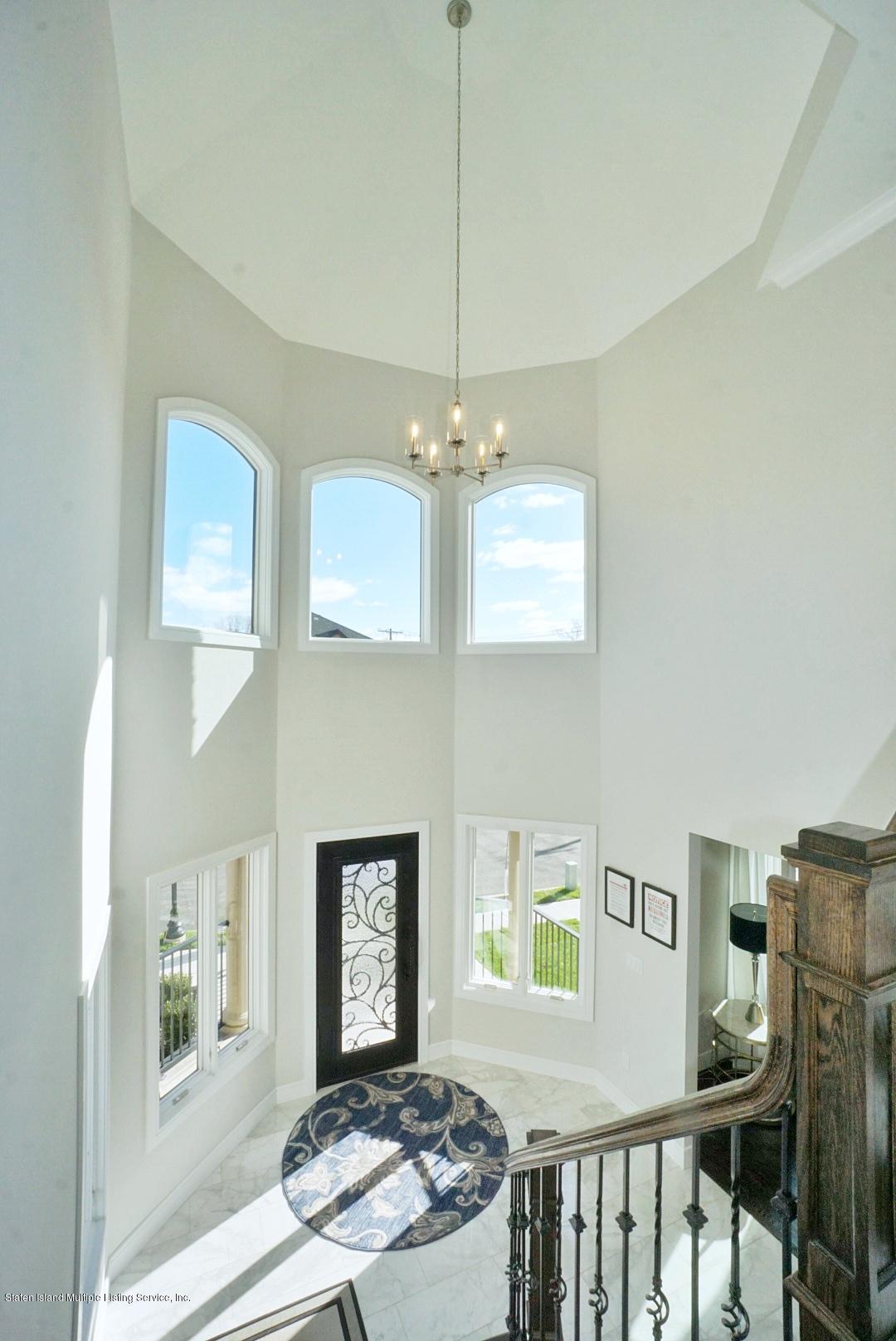 31 Torrice Loop Staten Island, NY 10309 - Photo 31 of 69 a bedroom with furniture a window and a chandelier