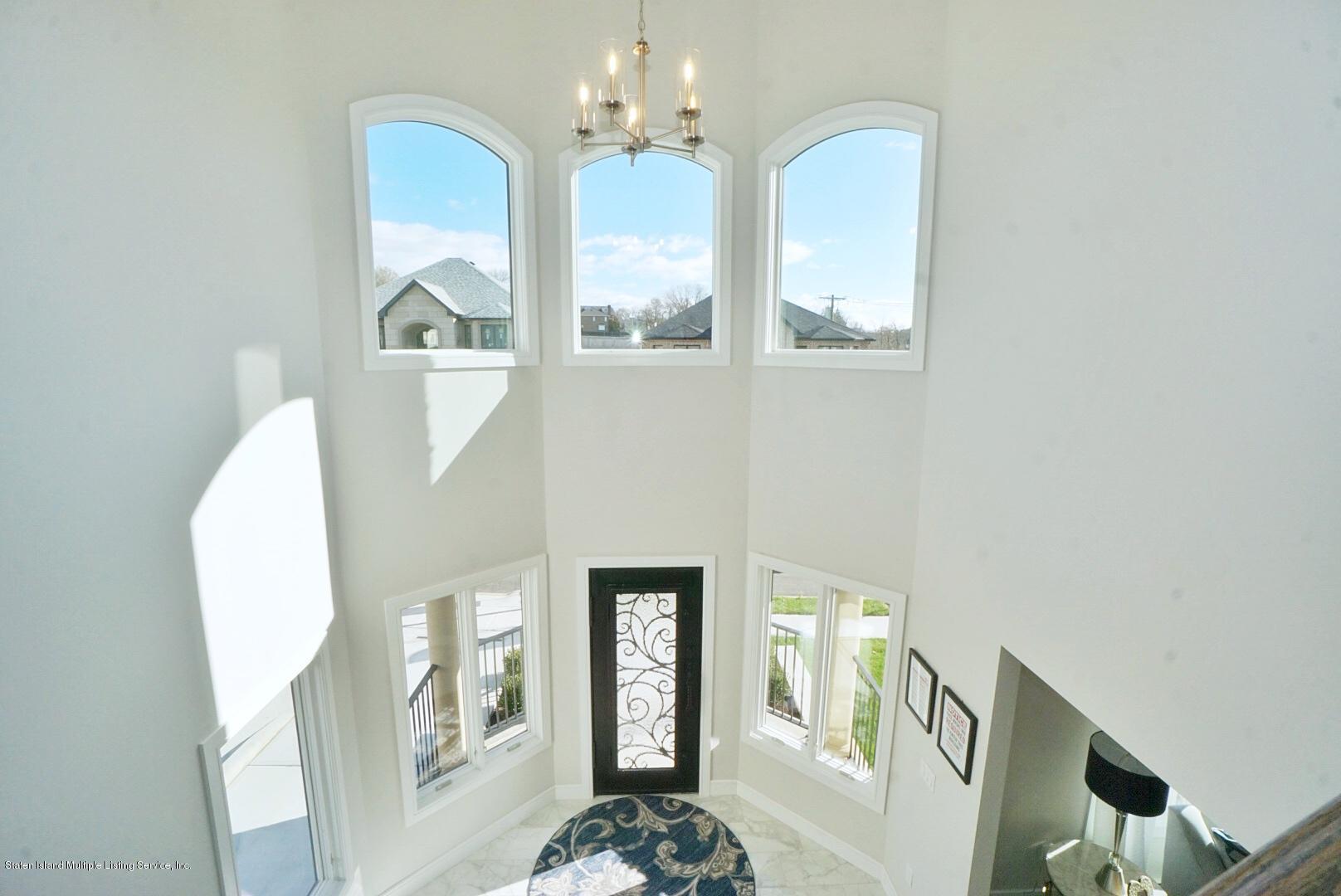 31 Torrice Loop Staten Island, NY 10309 - Photo 32 of 69 a view of a hallway with windows and chandelier