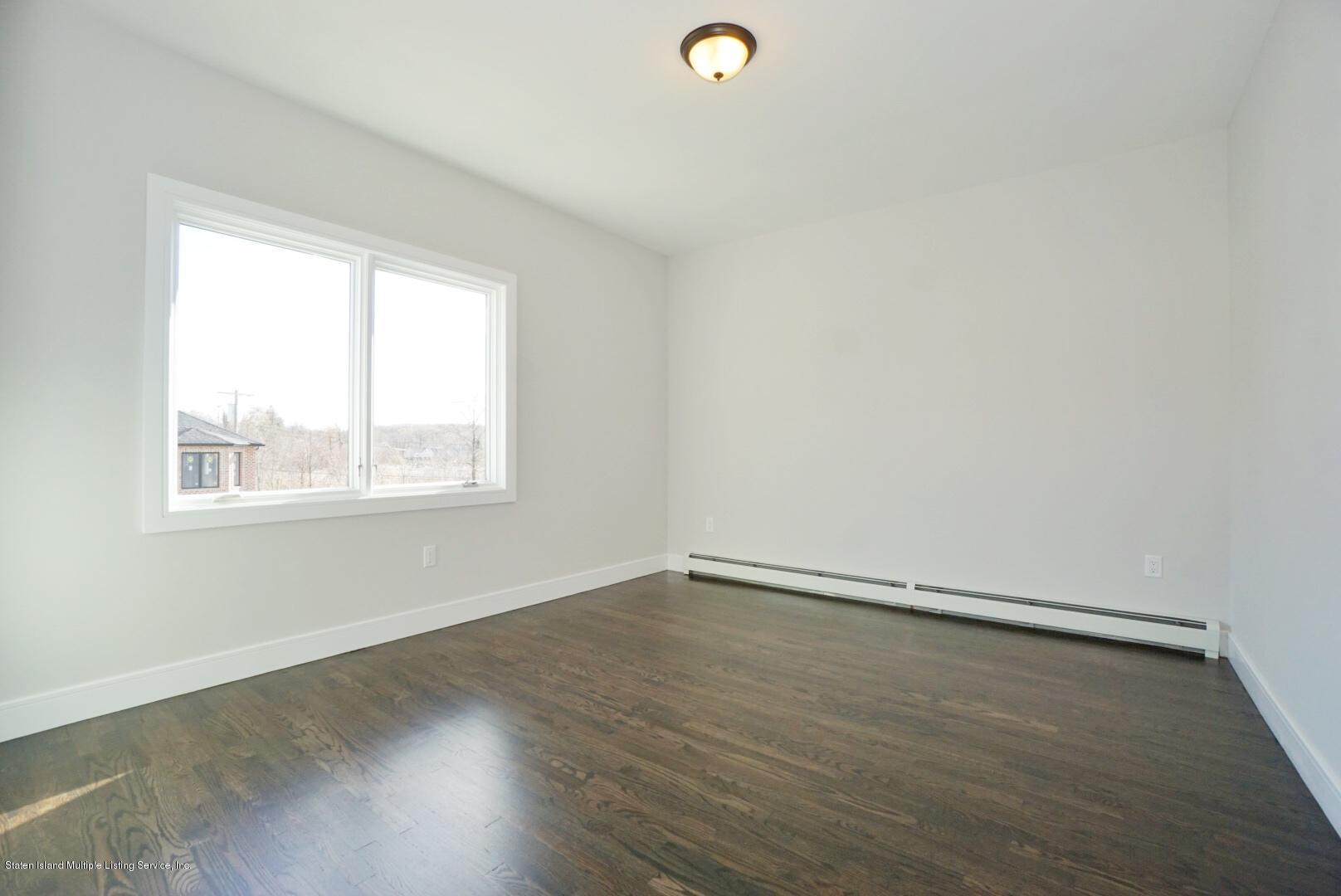 31 Torrice Loop Staten Island, NY 10309 - Photo 33 of 69 an empty room with wooden floor and windows