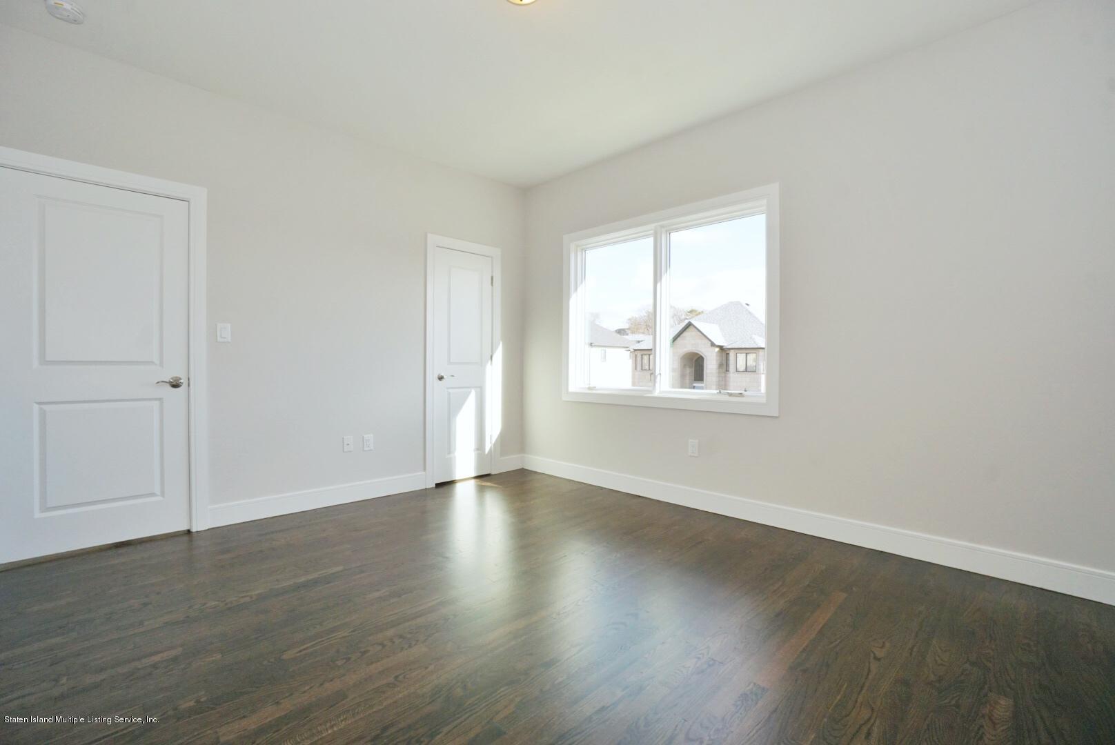 31 Torrice Loop Staten Island, NY 10309 - Photo 34 of 69 an empty room with wooden floor and windows
