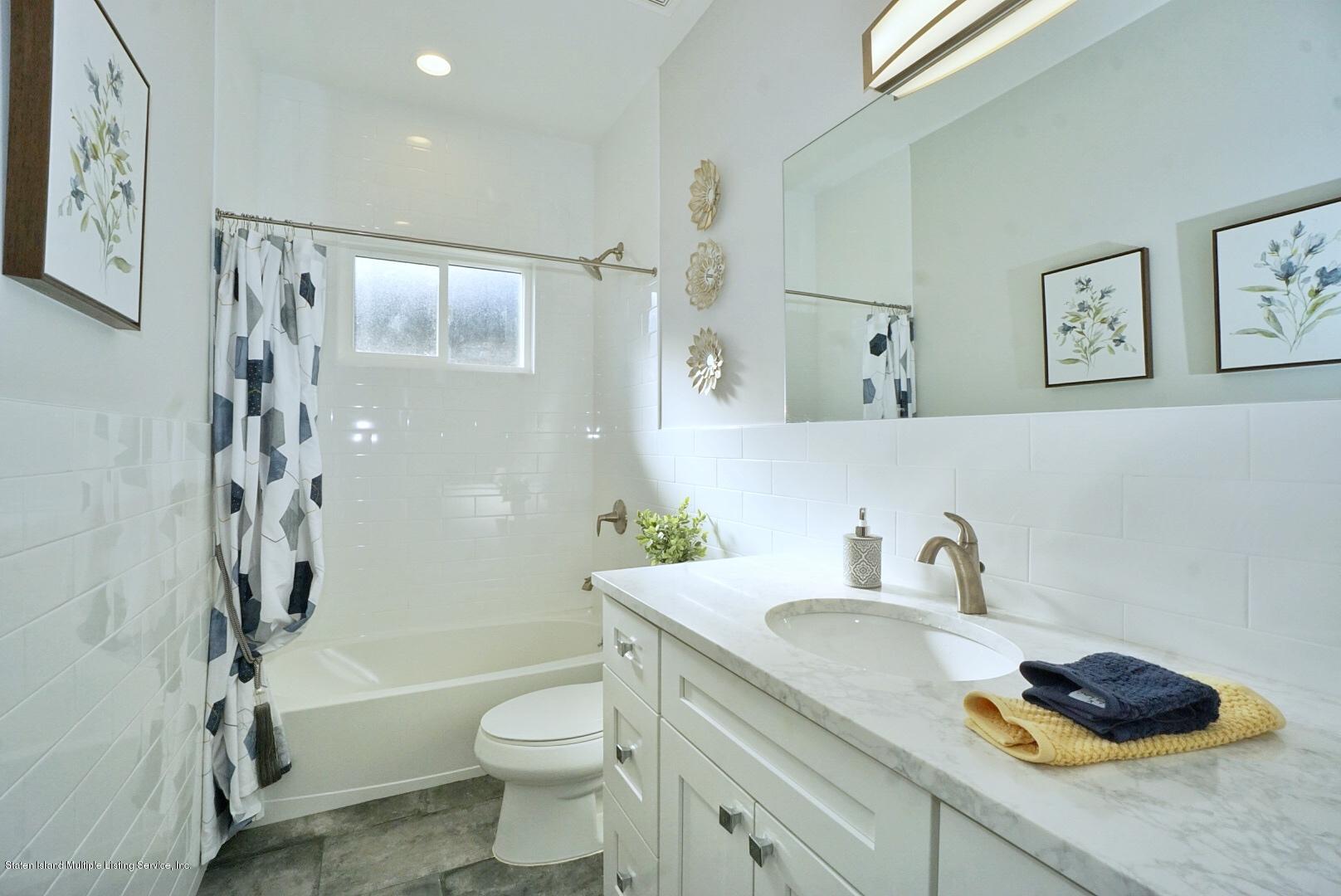 31 Torrice Loop Staten Island, NY 10309 - Photo 36 of 69 a bathroom with a granite countertop sink toilet and shower
