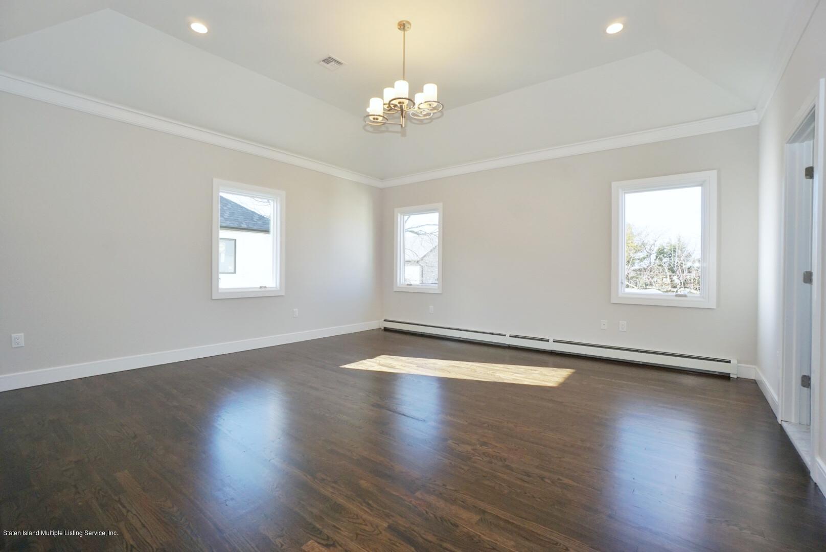 31 Torrice Loop Staten Island, NY 10309 - Photo 42 of 69 a view of an empty room with wooden floor and a window