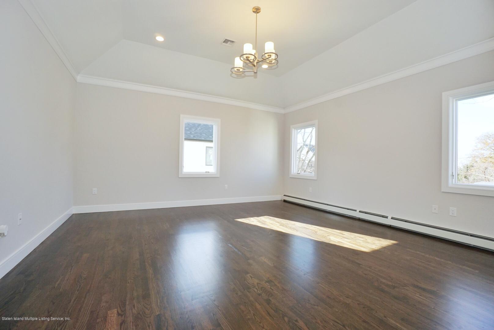 31 Torrice Loop Staten Island, NY 10309 - Photo 43 of 69 an empty room with wooden floor and windows