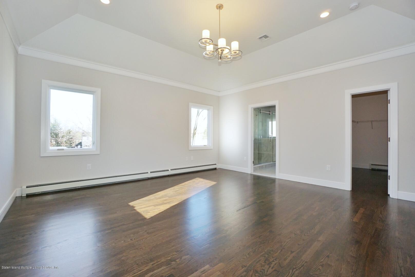 31 Torrice Loop Staten Island, NY 10309 - Photo 44 of 69 a view of an empty room with wooden floor and a window