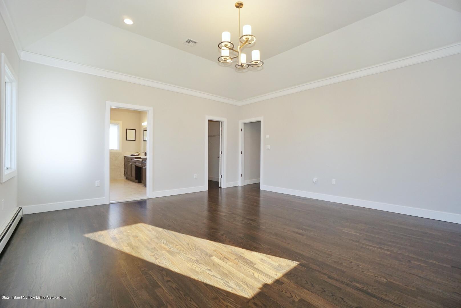 31 Torrice Loop Staten Island, NY 10309 - Photo 45 of 69 a view of a livingroom with wooden floor and a large window