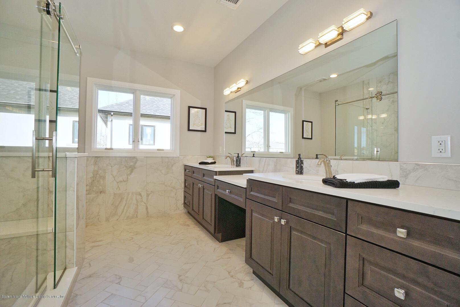 31 Torrice Loop Staten Island, NY 10309 - Photo 48 of 69 a spacious bathroom with a shower a sink and mirror